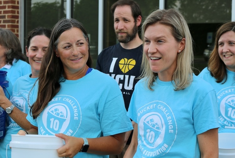 Kelly Gwathmey stands with members of the ALS clinic before dumping buckets filled with ice water on their heads.