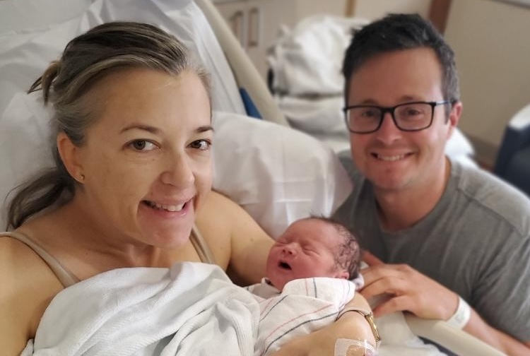 Mom and dad in hospital room with newborn