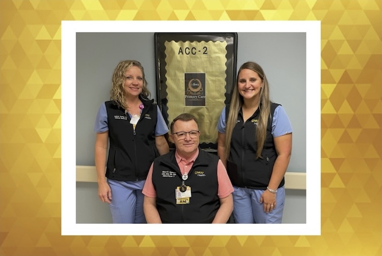 three people standing together outside their clinic in scrubs