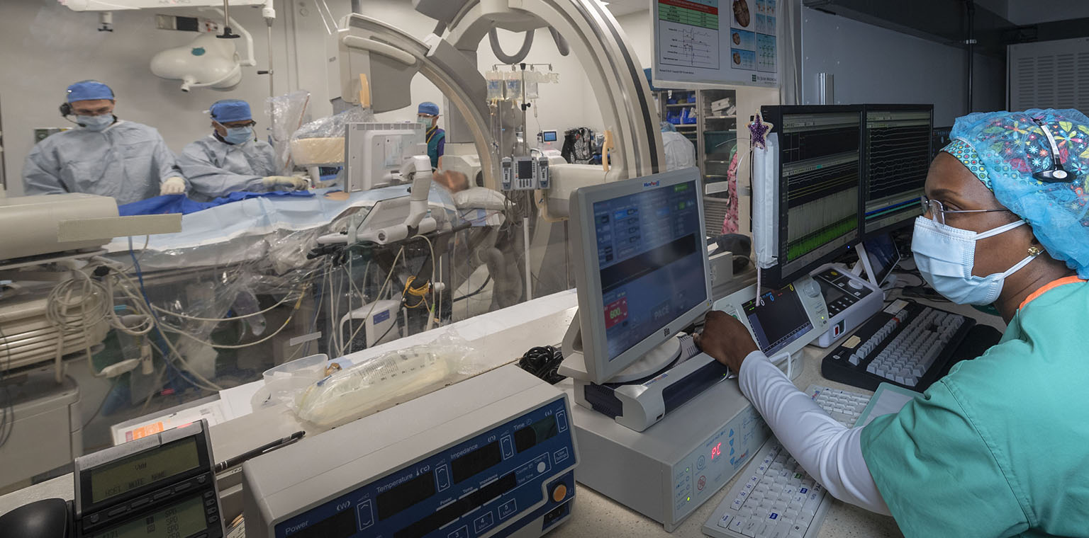 Dr. Karoly Kaszala and EP team perform a procedure in the VA electrophysiology lab. Other team members pictured are Dr. Ajay Pillai, electrophysiology fellow at the operating table, Dr. Darrin Gould from anesthesiology and nurse Nathalie Tomety assisting at the recording system.