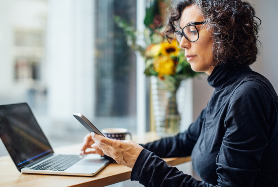 Woman with cell phone and laptop