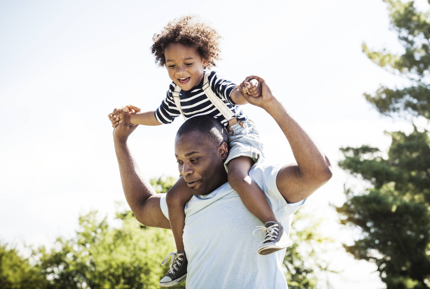 Child riding on a mans shoulders