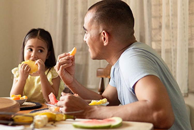 dad and daughter eating breakfast together