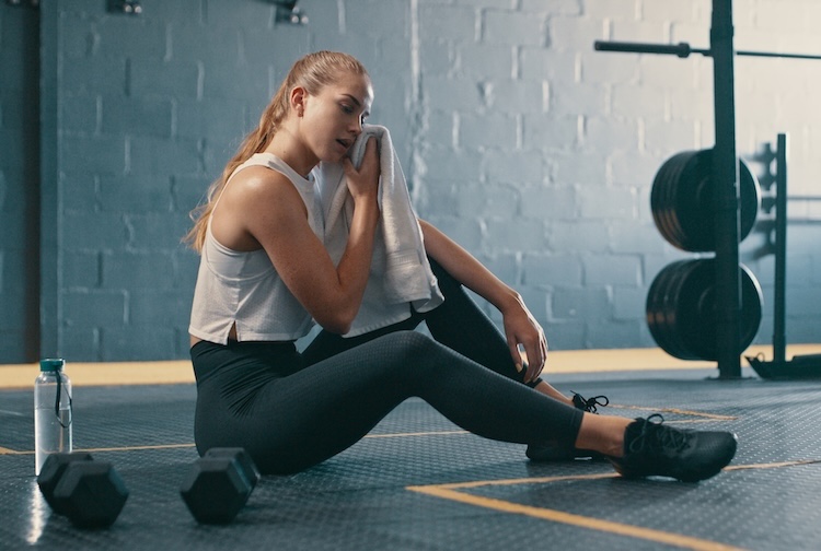 Woman wiping away sweat after working out