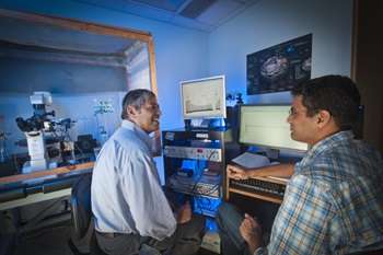 Hamid Akbarali, Ph.D. assists a graduate student in the Department of Pharmacology and Toxicology in the School of Medicine.<br>Photo by Allen Jones, University Marketing.