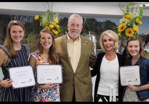 Scholarship recipients stand with Joyce and Rich.