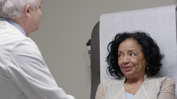 Doctor talks to patient in medical clinic. 