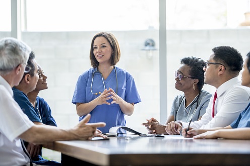 Medical professional speaking to a diverse group of people